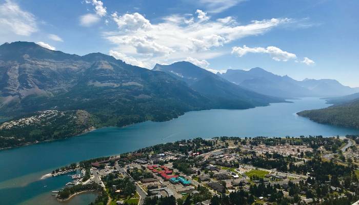 A photo of Waterton Lakes National Park at the top of a mountain looking down at the lakes and townsite. Being in the moment on a hike or out in nature can instil a feeling of enlightenment.