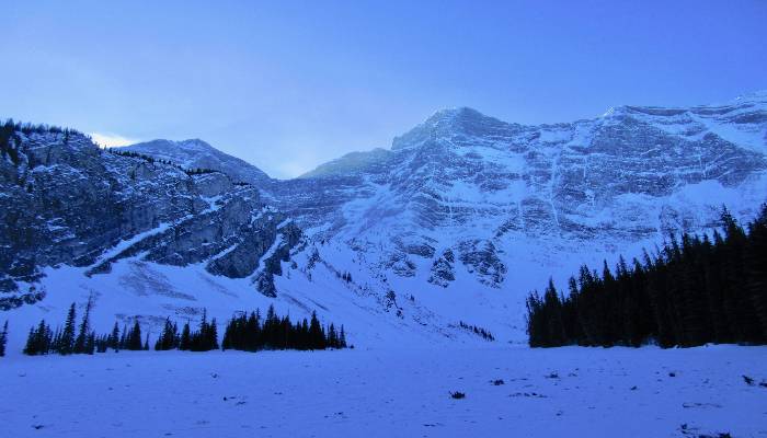 A photo of a snowshoe up to Rawson Lake, Kananaskis, the mountains glistening in the sun, offering glimmers of hope for a healthy mindset where you can manifest positive change in your life.