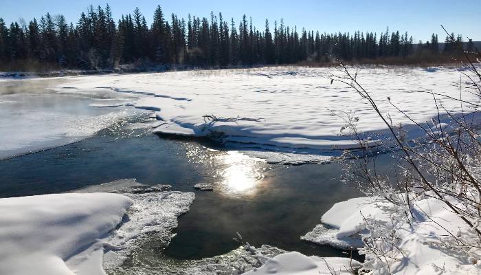 A photo of a river with flowing water, snow, and ice in Calgary, Alberta, Canada. A good place where we can stop overthinking.