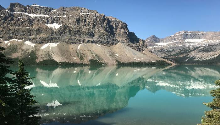 A photo of a reflective Bow Lake, Icefields Parkway, Alberta, Canada. Our thoughts are a reflection of our minds, so keep your negative self-talk at bay.