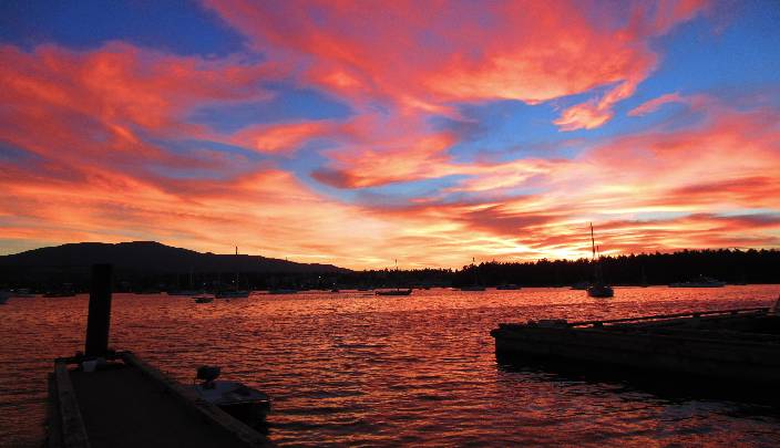 A photo of a brilliant red-orange sunset in Nanaimo, BC, Canada that reminds us of unconditional love and melting the armour of our hearts.