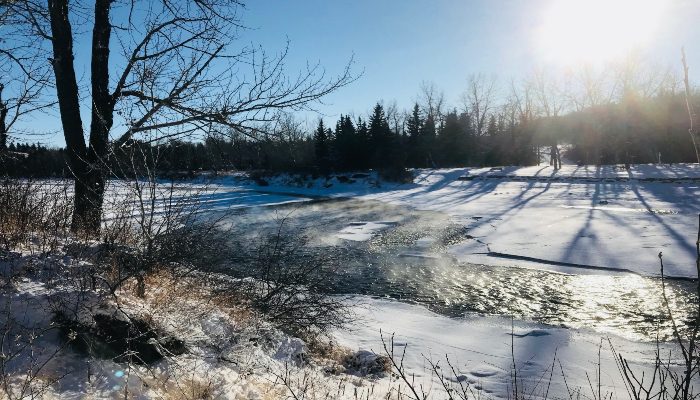 A photo of a chilly winter scene in Calgary, Alberta, Canada with steam rising off the water. A good time to go inwards for self love and self care.