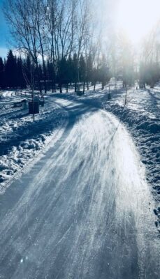 A photo of some expansive ice skating ice glistening in the sun. We can become more expansive ourselves through self-awareness exercises.