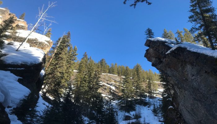 A photo of Sundance Canyon in Banff, Alberta, Canada. Standing in the shadows, we often come into self-doubt. Overcoming self-doubt and being kind to ourselves is important.