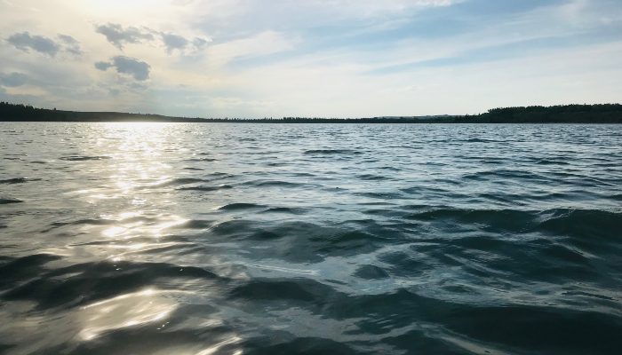 A photo of some beautiful kayaking waters and sun glistening off the water in Calgary, Alberta to help you learn how to stop feeling overwhelmed by life.