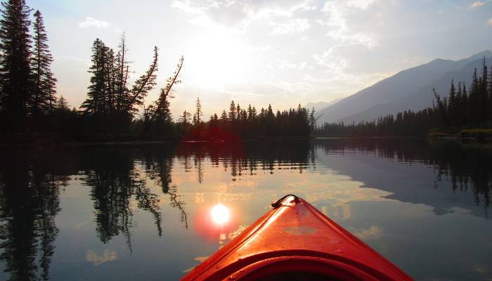A photo of a red kayak tip in Banff, Alberta, very peaceful waters helping you be mindful in mind, body, spirit.